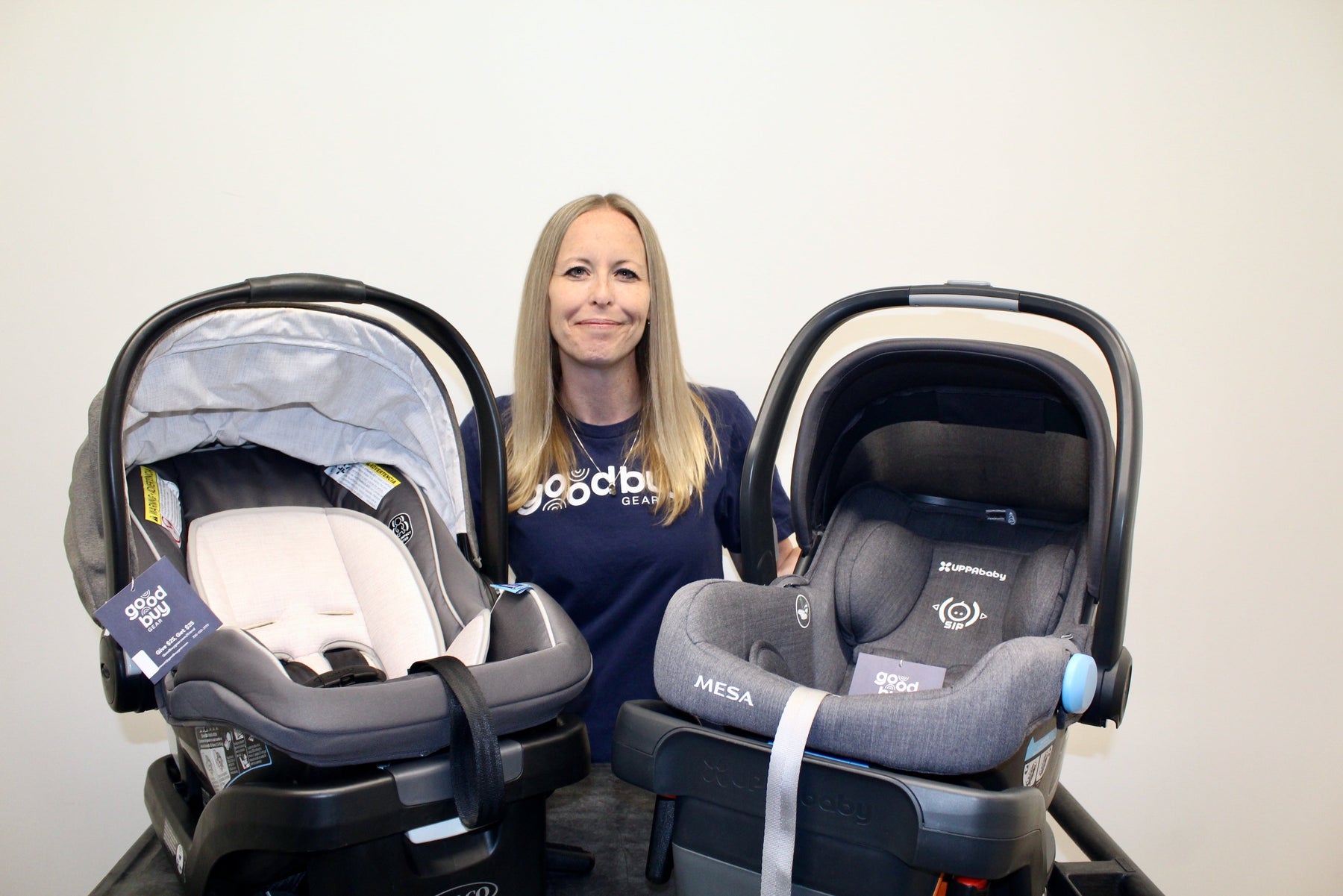 Amanda, GoodBuy Gear's In-House CPST holding two car seats