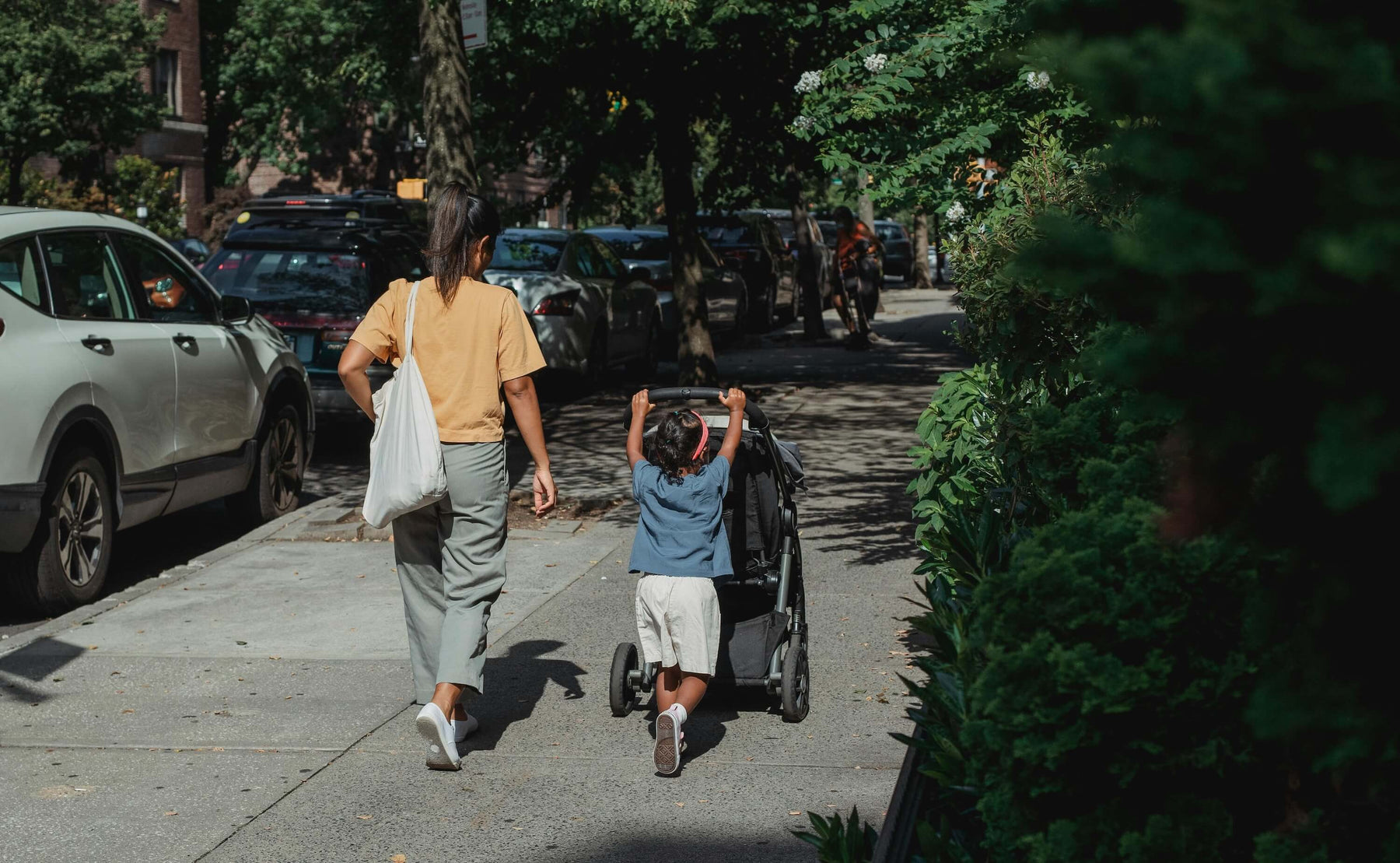 Mom walking with her daughter in the city 