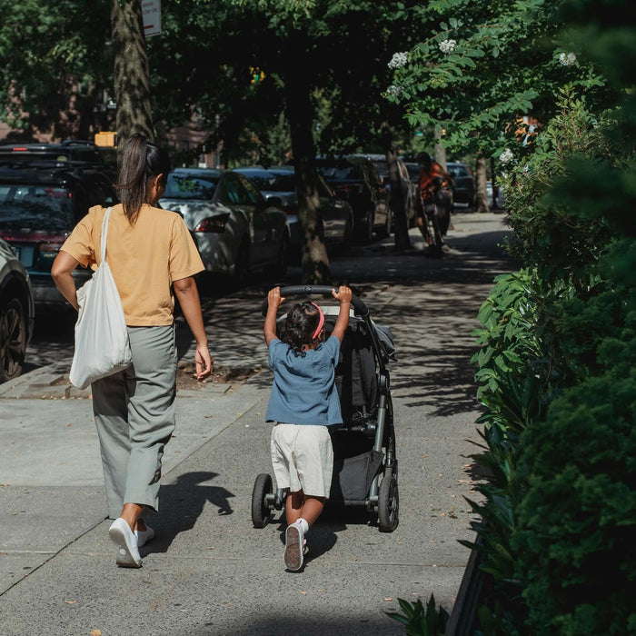 Mom walking with her daughter in the city 