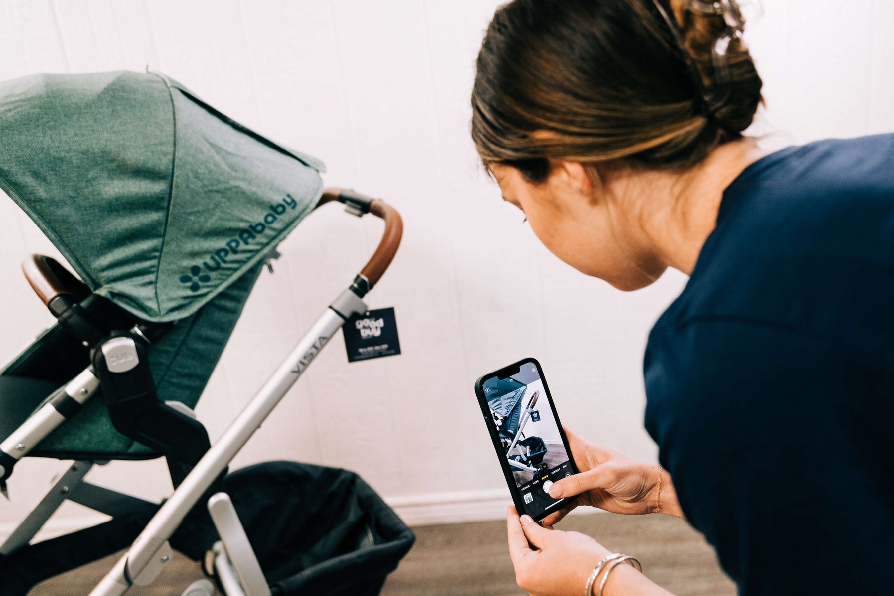 GoodBuy Gear employee quality checking a secondhand UPPAbaby strollers