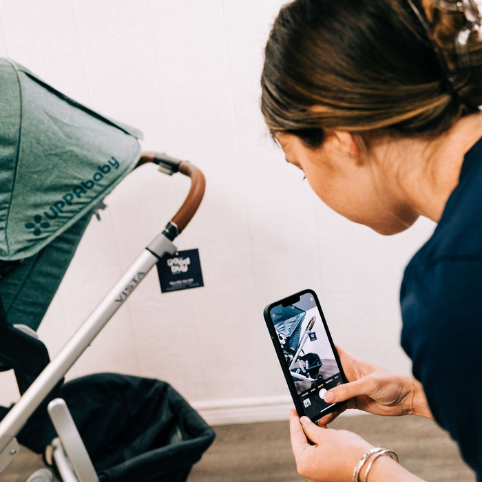 GoodBuy Gear employee quality checking a secondhand UPPAbaby strollers