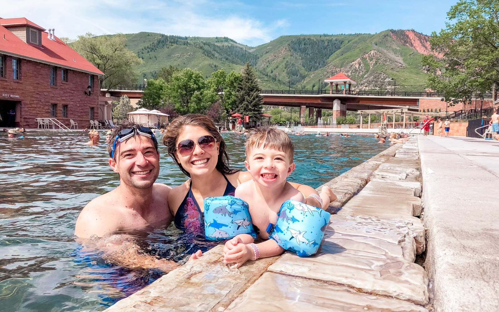 family of 3 swimming at a pool at a resort in Colorado