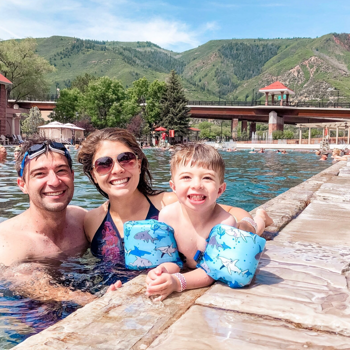 family of 3 swimming at a pool at a resort in Colorado