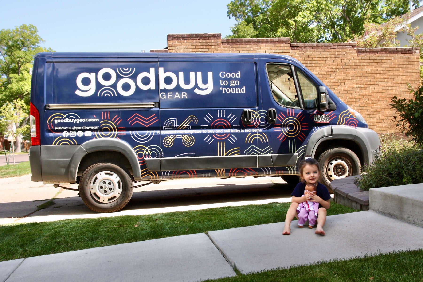 GoodBuy Gear Van outside of a house picking up gently used baby gear