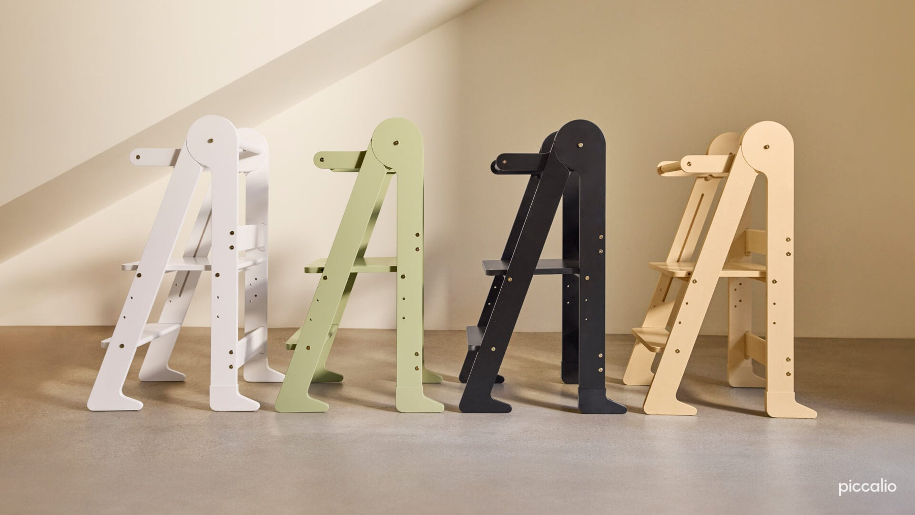 Four Piccalio toddler towers in different colors lined up next to eachother