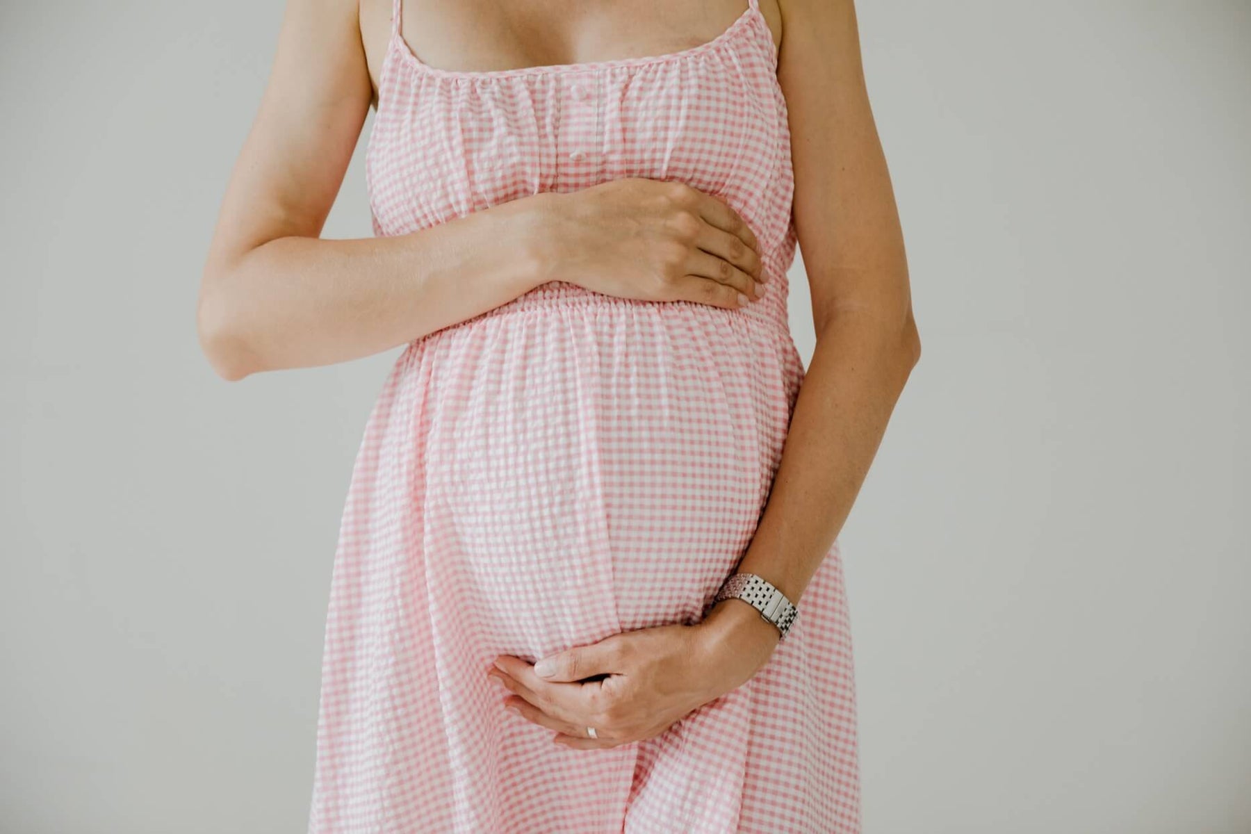 pregnant woman holding her belly