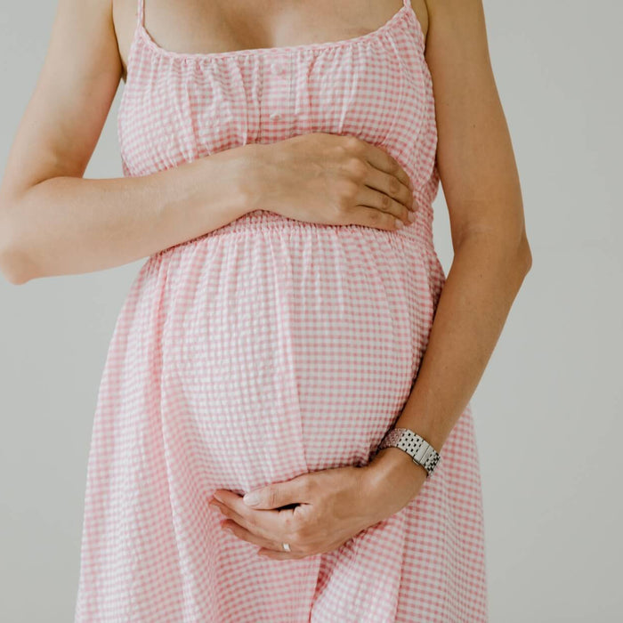 pregnant woman holding her belly