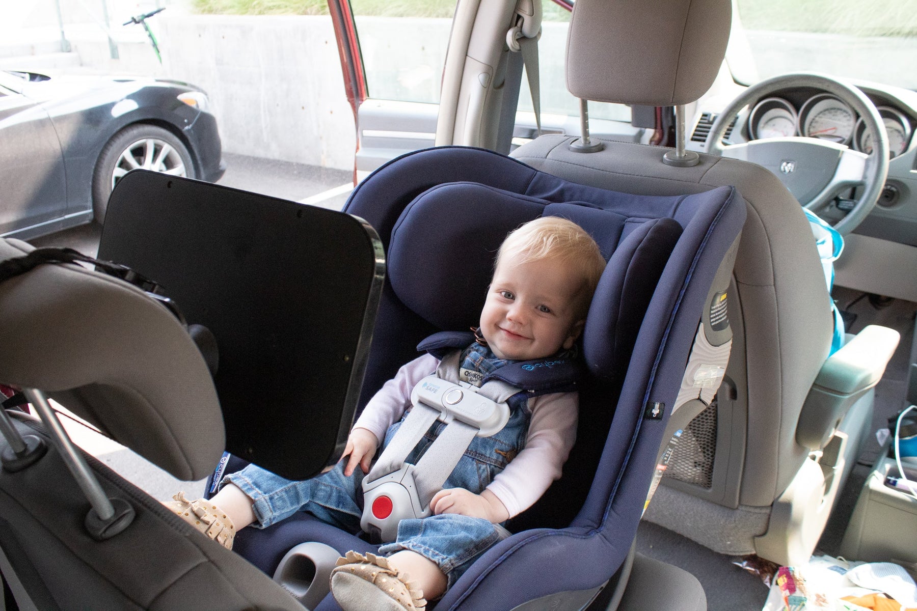 a toddler in a car seat during a road trip