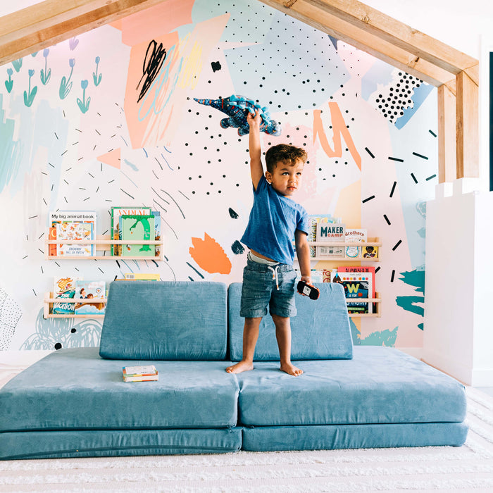 toddler playing inside with a stuffed animal 