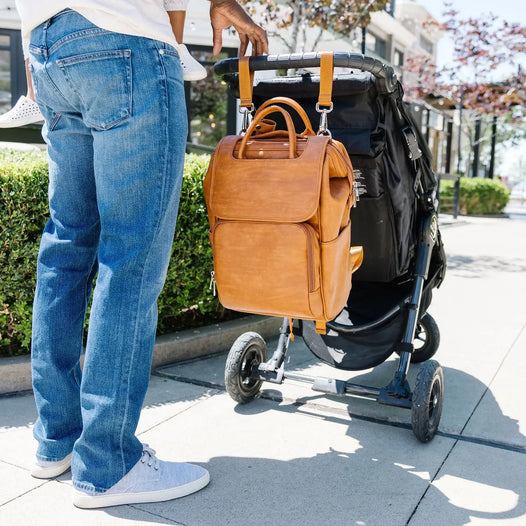 dad carrying a diaper bag on his stroller