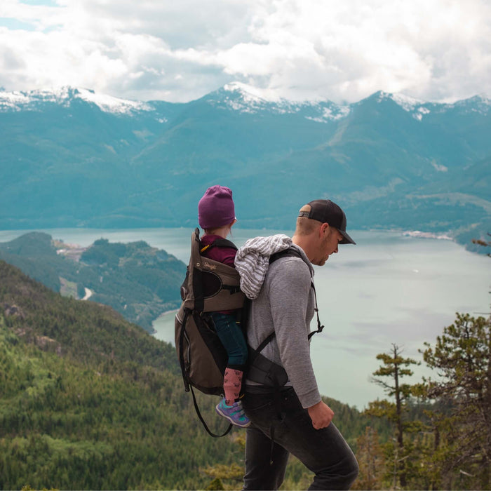 Father and daughter hiking during the fall in Colorado overlooking a lake