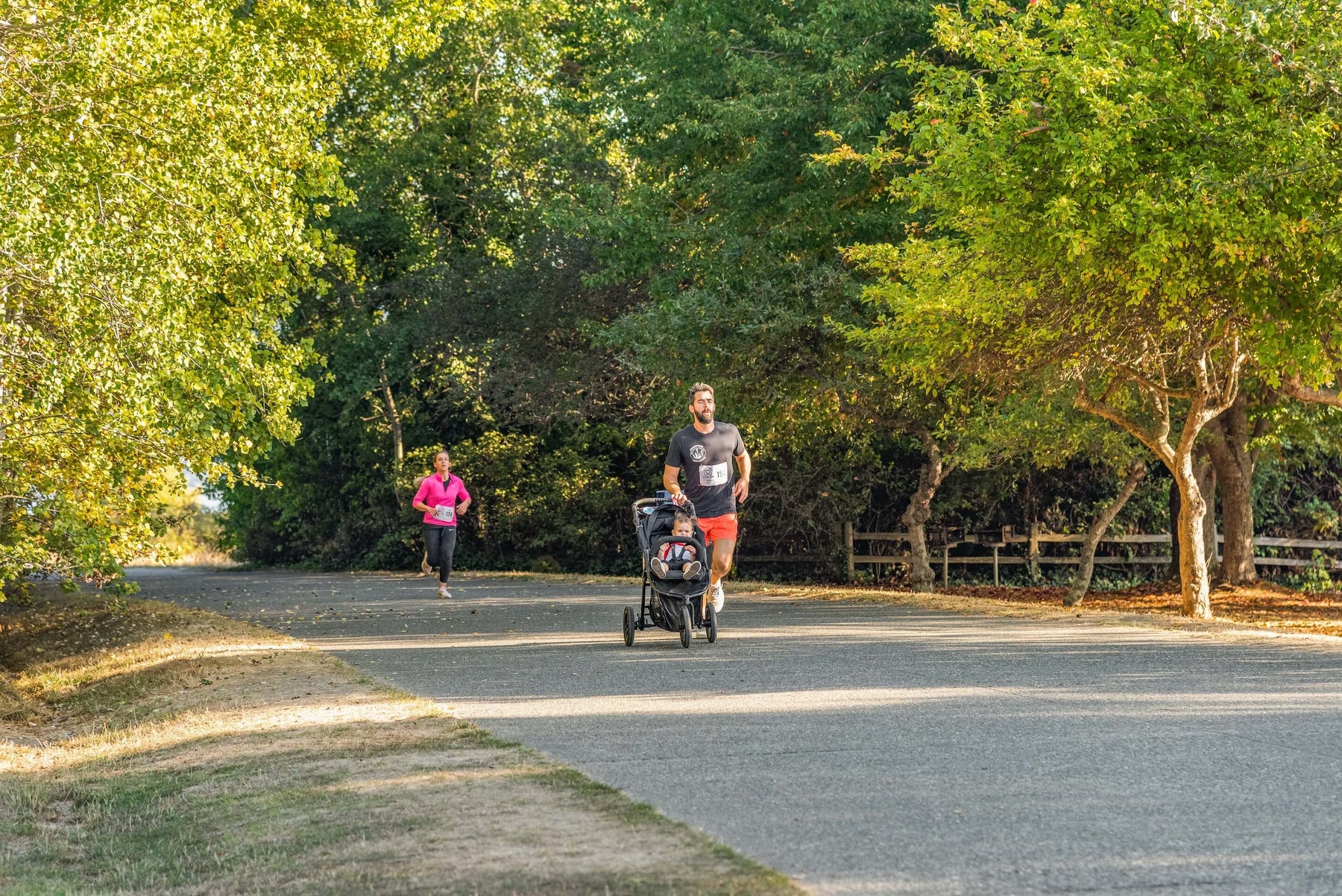 dad jogging with his little one in a jogging stroller