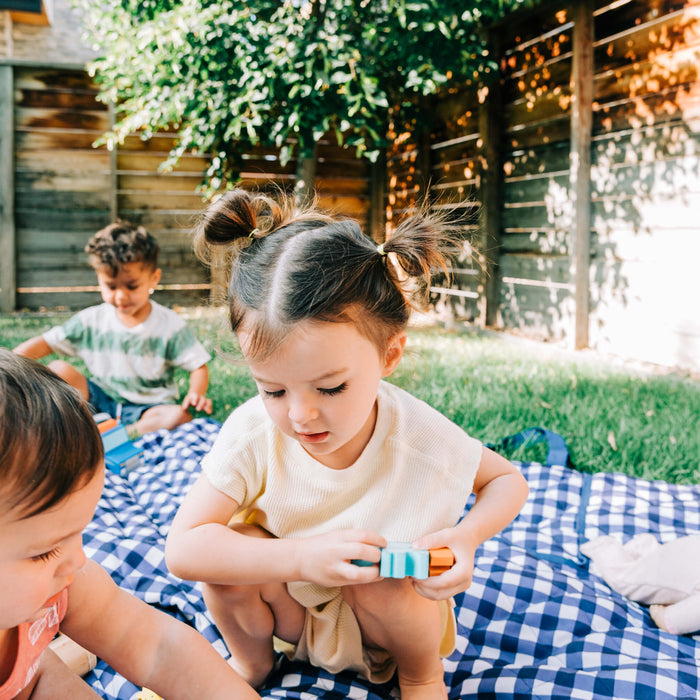 kids playing outside with wooden toys