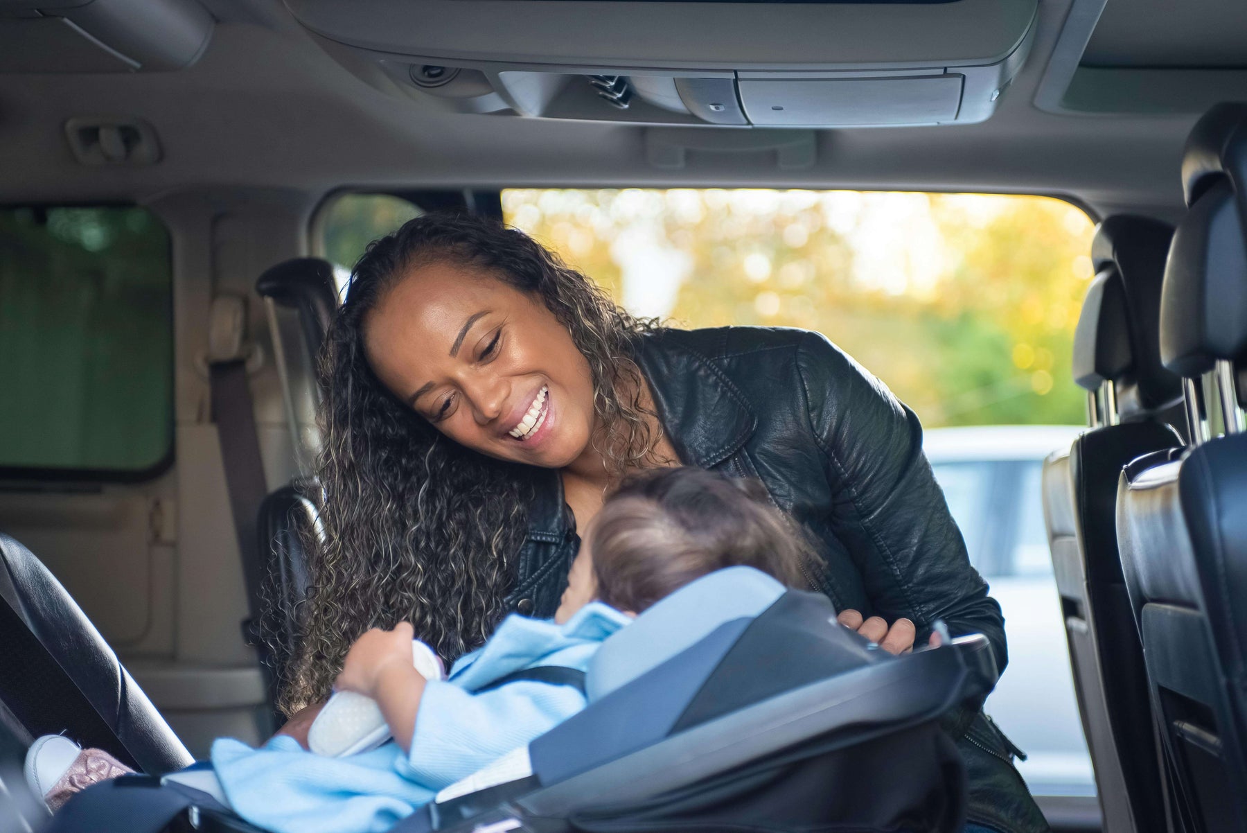a toddler in a car seat during a road trip