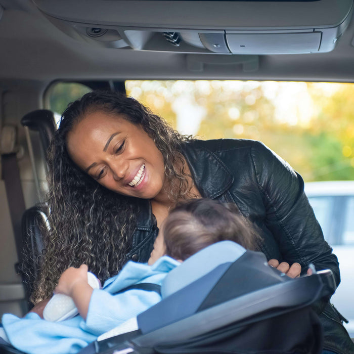 a toddler in a car seat during a road trip