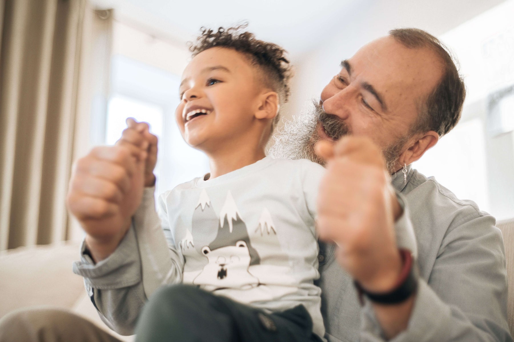 Grandpa holding his grandkid and smiling