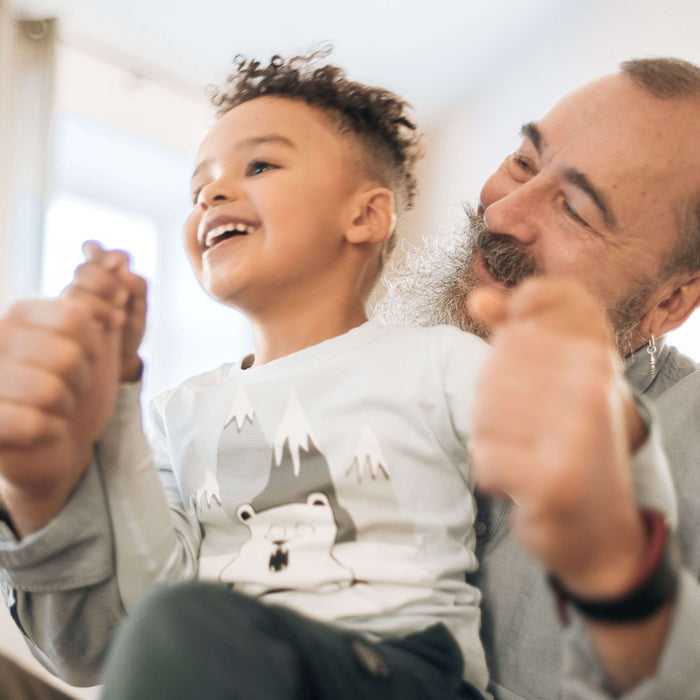 Grandpa holding his grandkid and smiling