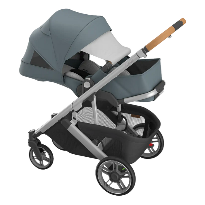 Gray and black stroller with a baby seat on a white background