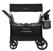 Black baby stroller with canopy on a bright green background