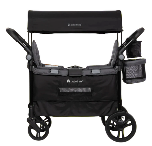 Black baby stroller with canopy on a bright green background
