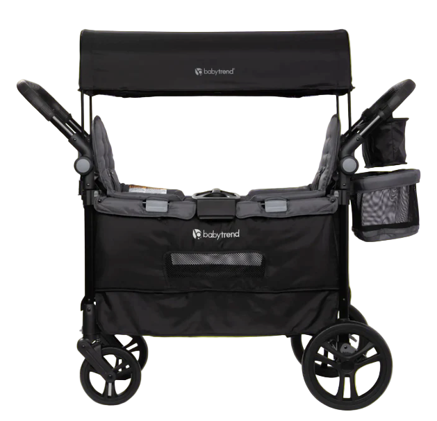 Black baby stroller with canopy on a bright green background