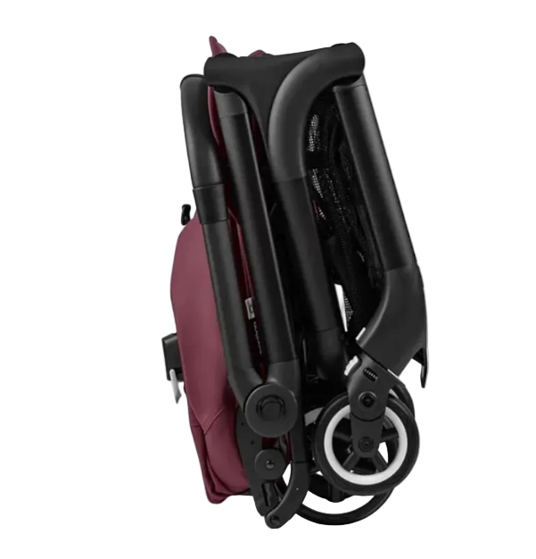 Folded baby stroller with red seat on a white background