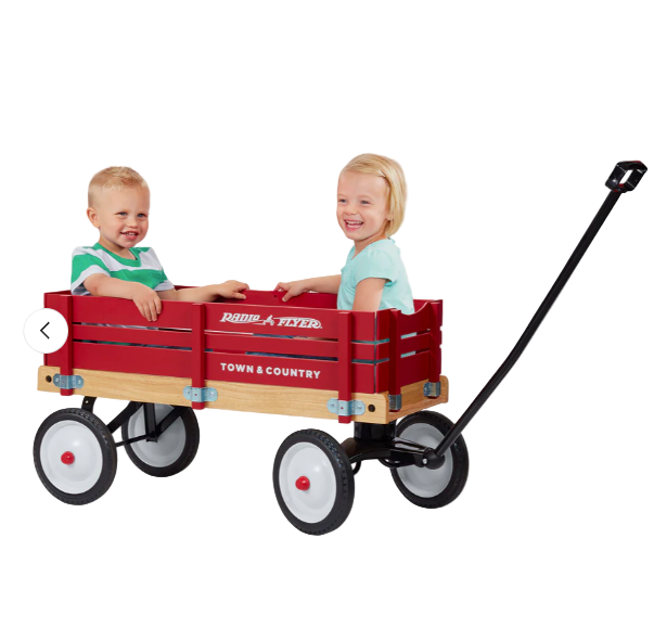 Two children sitting in a red Radio Flyer wagon on a white background