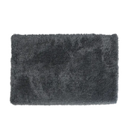 Dark gray shaggy rug on a white background