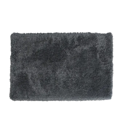 Dark gray shaggy rug on a white background