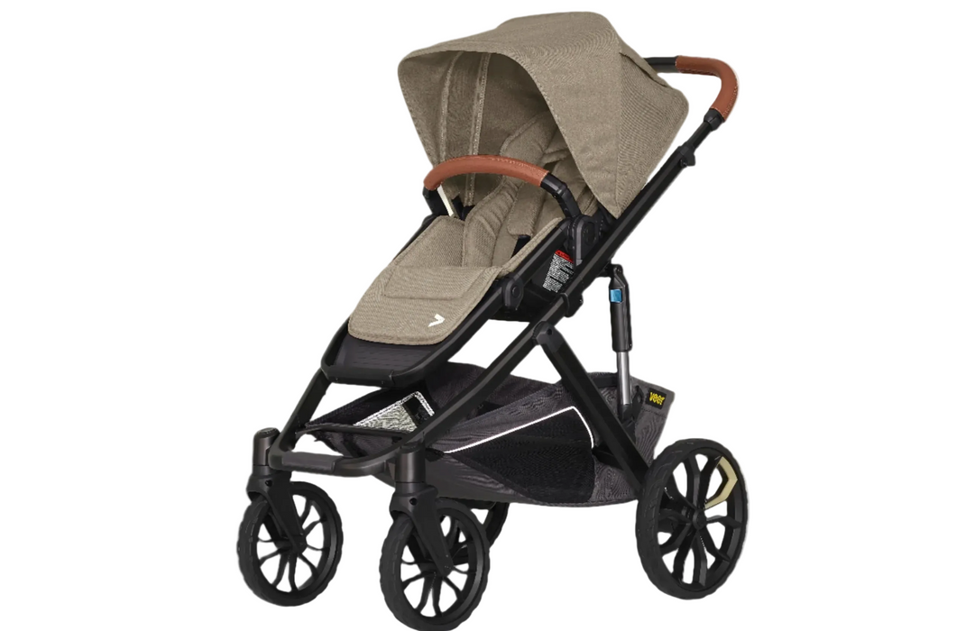 Beige and black stroller on a white background