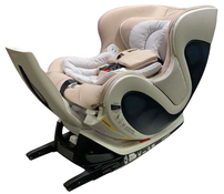 Beige and gray baby car seat with black base on a white background